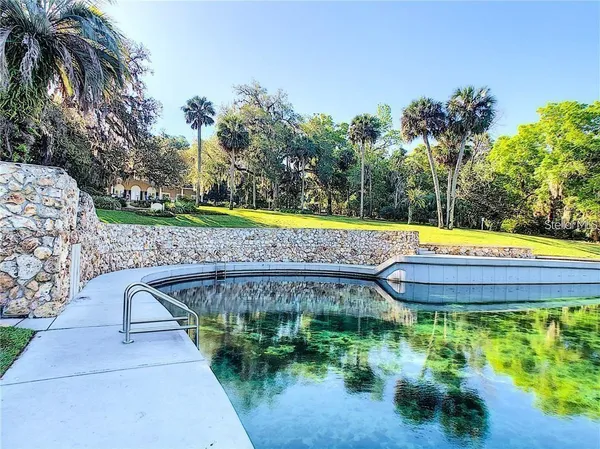 a swimming pool with outdoor seating