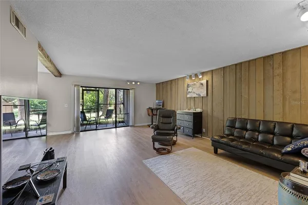 a living room with furniture window and wooden floor