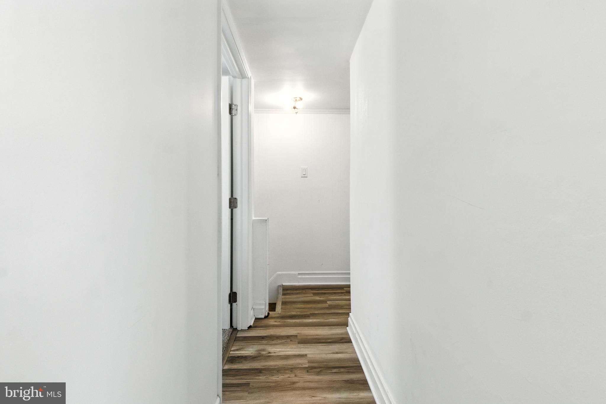 1745 Filbert Street York, PA 17404 - Photo 16 of 26 a view of a hallway with wooden floor and a bathroom