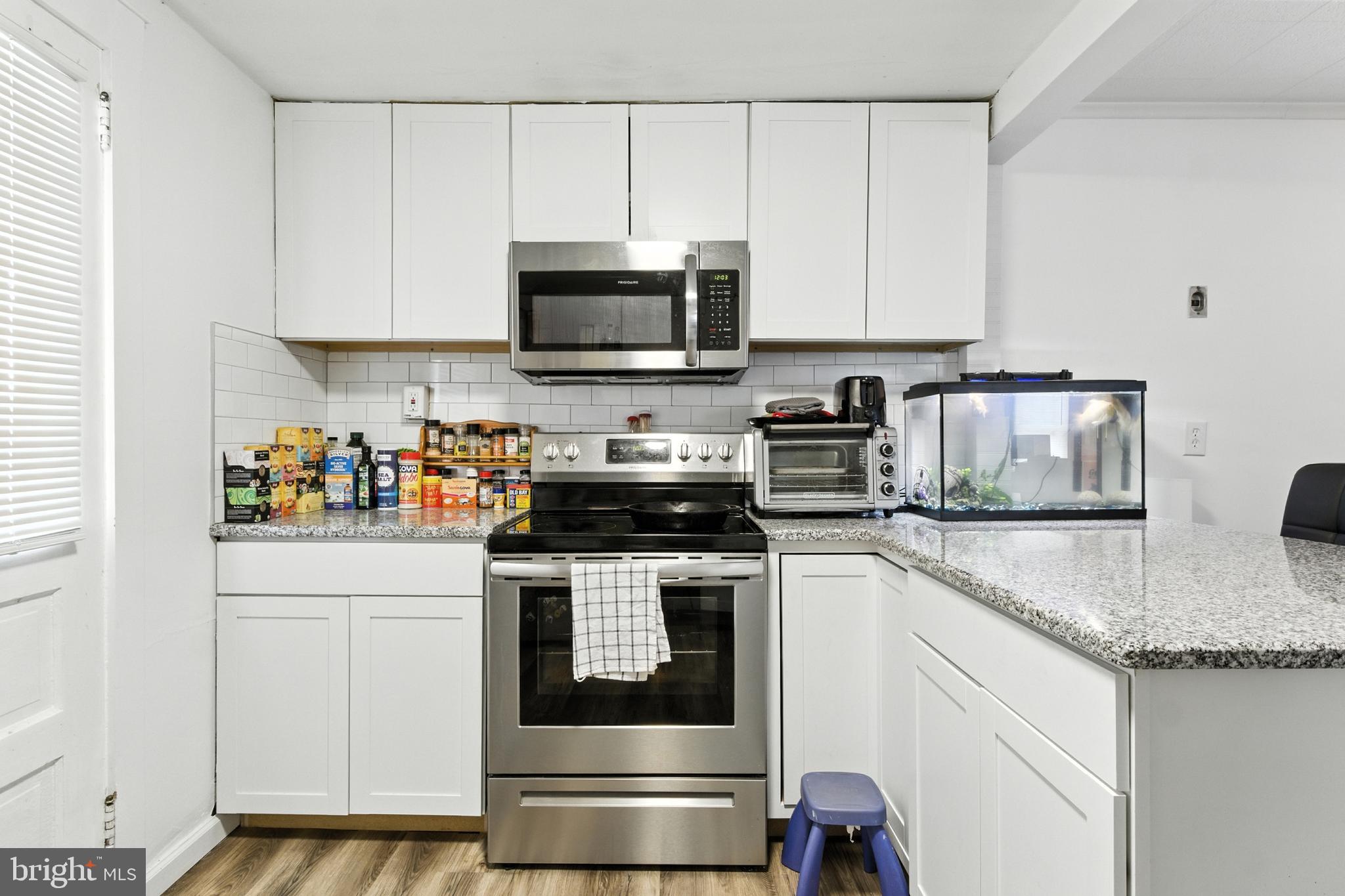 1745 Filbert Street York, PA 17404 - Photo 8 of 26 a kitchen with stainless steel appliances granite countertop a sink a stove and white cabinets