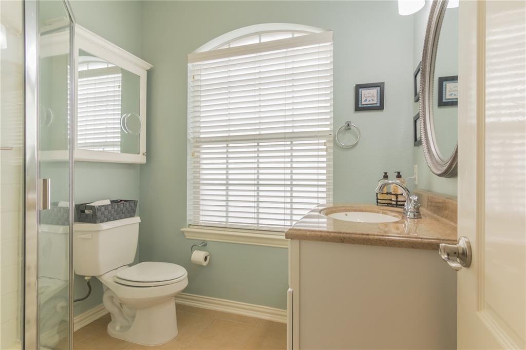 252 Pond View Pass Buda, TX 78610 - Photo 20 of 37 Full bath featuring vanity, healthy amount of natural light, a shower with shower door, and light tile patterned floors