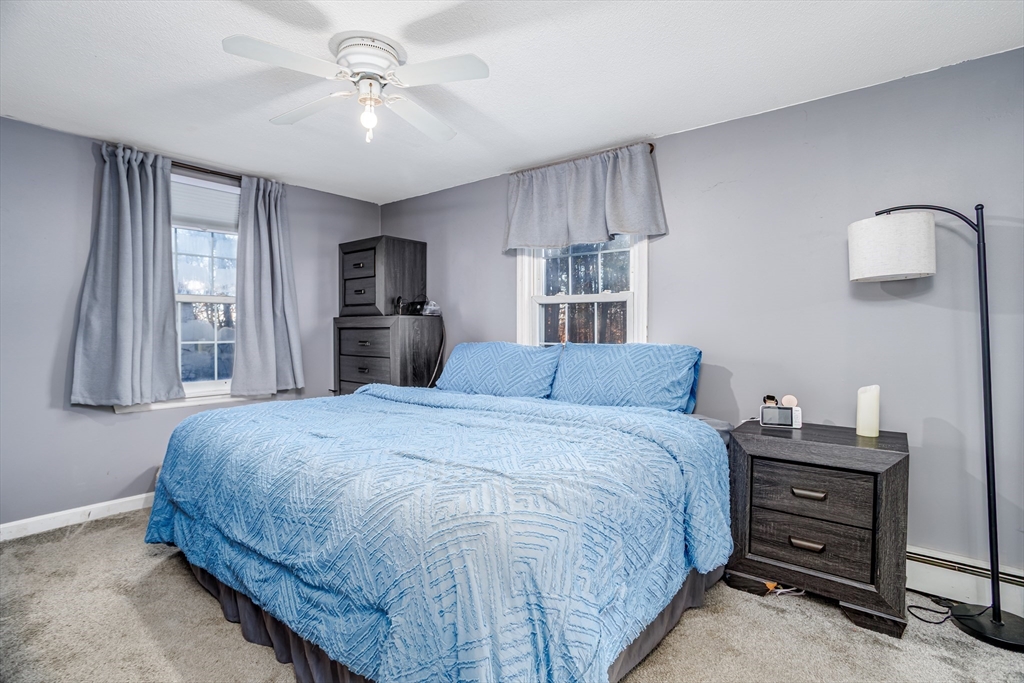 18 Corey Hill Road Ashburnham, MA 01430 - Photo 26 of 40 a large bed sitting in a room next to a window