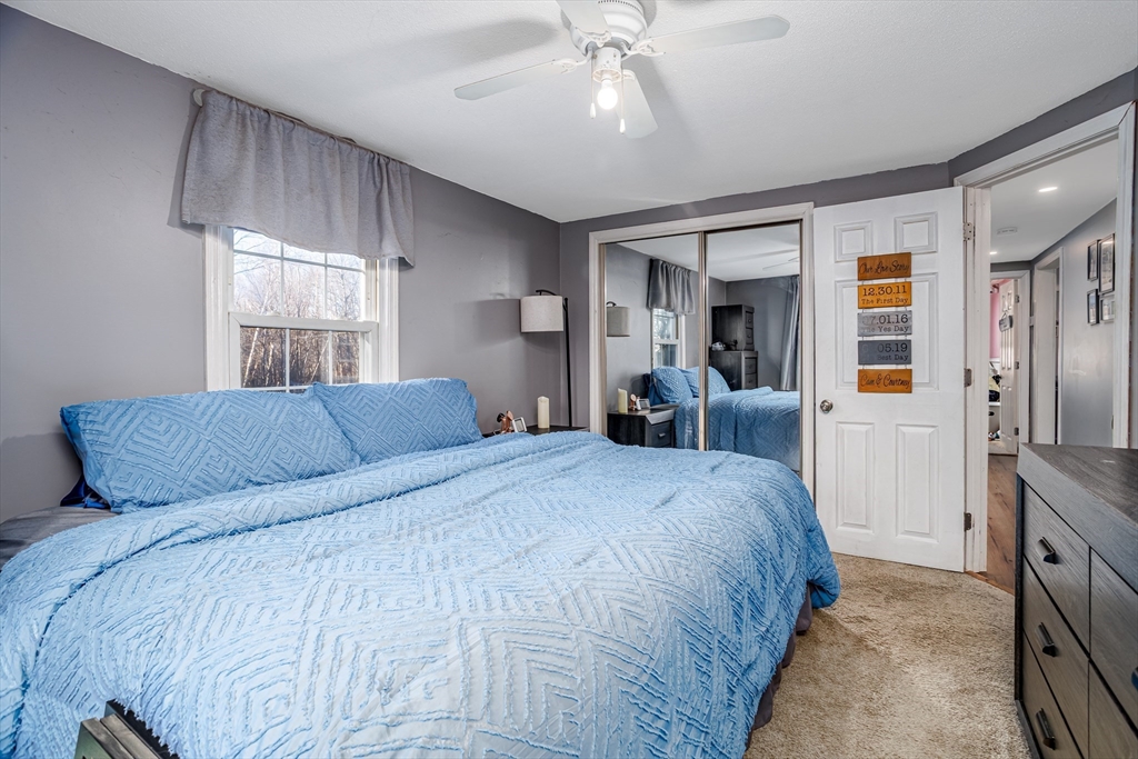 18 Corey Hill Road Ashburnham, MA 01430 - Photo 27 of 40 a bed room with a bed and a large mirror