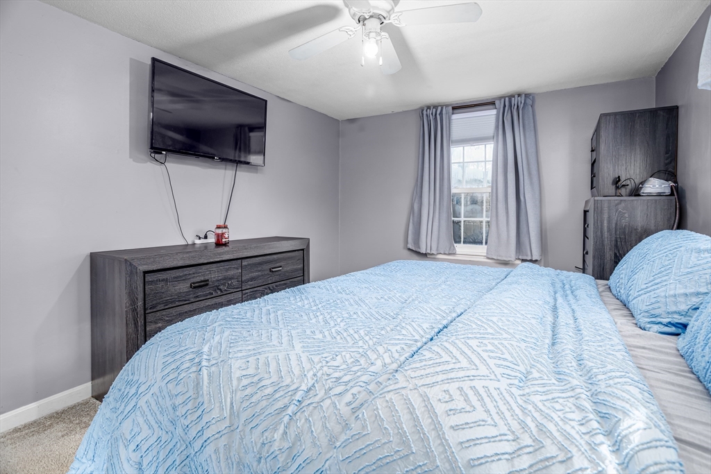 18 Corey Hill Road Ashburnham, MA 01430 - Photo 28 of 40 a bedroom with a bed and a flat screen tv