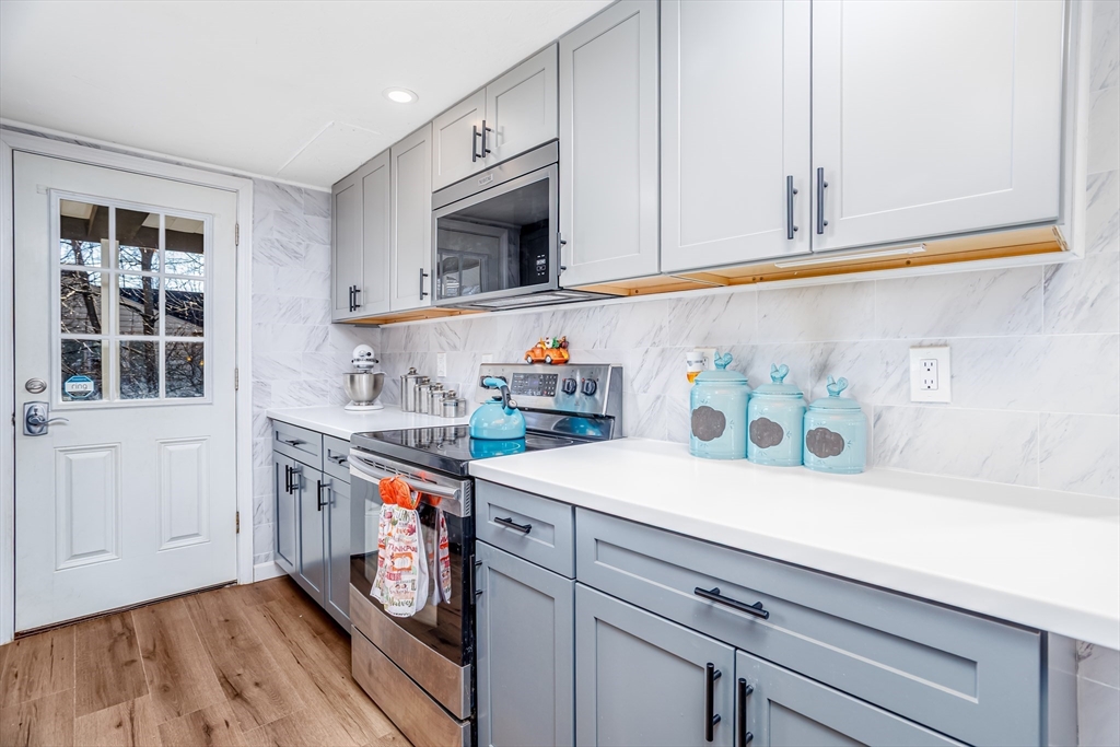 18 Corey Hill Road Ashburnham, MA 01430 - Photo 9 of 40 a kitchen with stainless steel appliances a sink a stove and cabinets