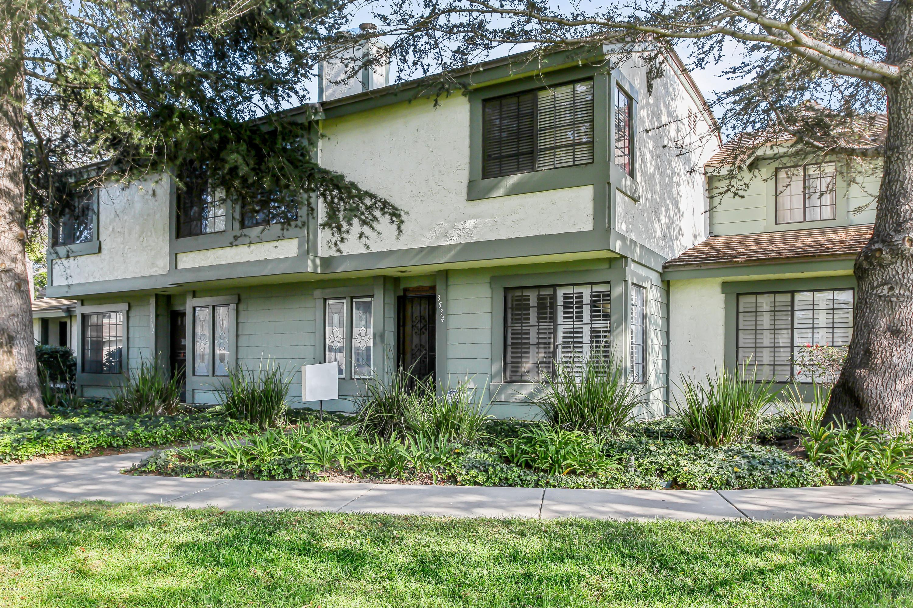 3534 Olds Road Oxnard, CA 93033 - Photo 1 of 14 a view of a house with brick walls plants and large tree