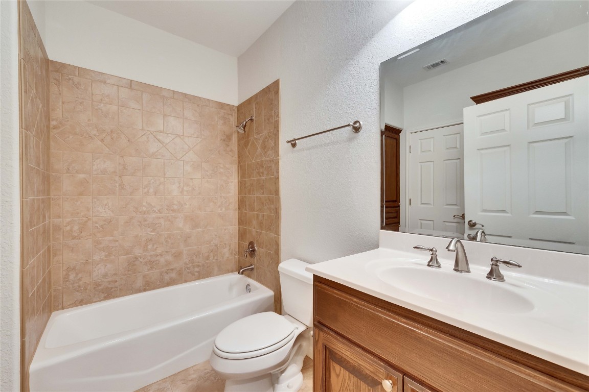 10300 Morado Cove, Unit 601 Austin, TX 78759 - Photo 15 of 20 a bathroom with a granite countertop sink toilet and shower