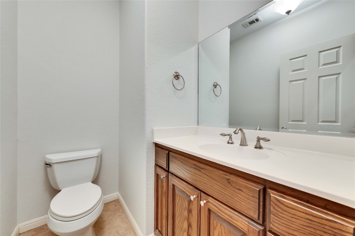 10300 Morado Cove, Unit 601 Austin, TX 78759 - Photo 16 of 20 a bathroom with a toilet sink and mirror