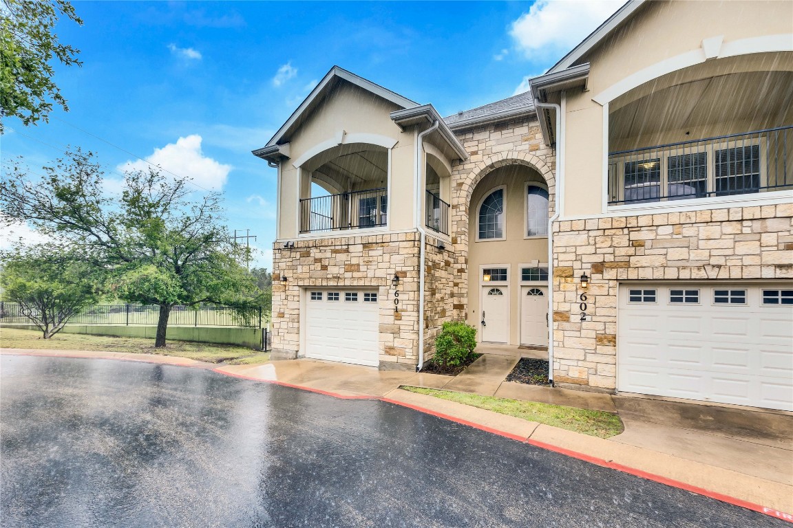 10300 Morado Cove, Unit 601 Austin, TX 78759 - Photo 20 of 20 a front view of a house with a yard and garage