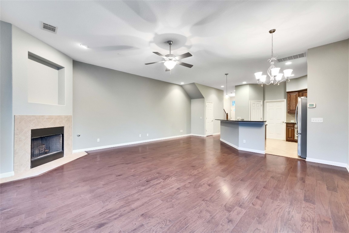 10300 Morado Cove, Unit 601 Austin, TX 78759 - Photo 3 of 20 a view of an empty room with a fireplace and chandelier fan