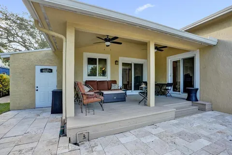 a view of a house with a yard and potted plants