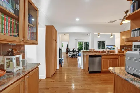 a kitchen with stainless steel appliances granite countertop a refrigerator a stove top oven a sink and dishwasher