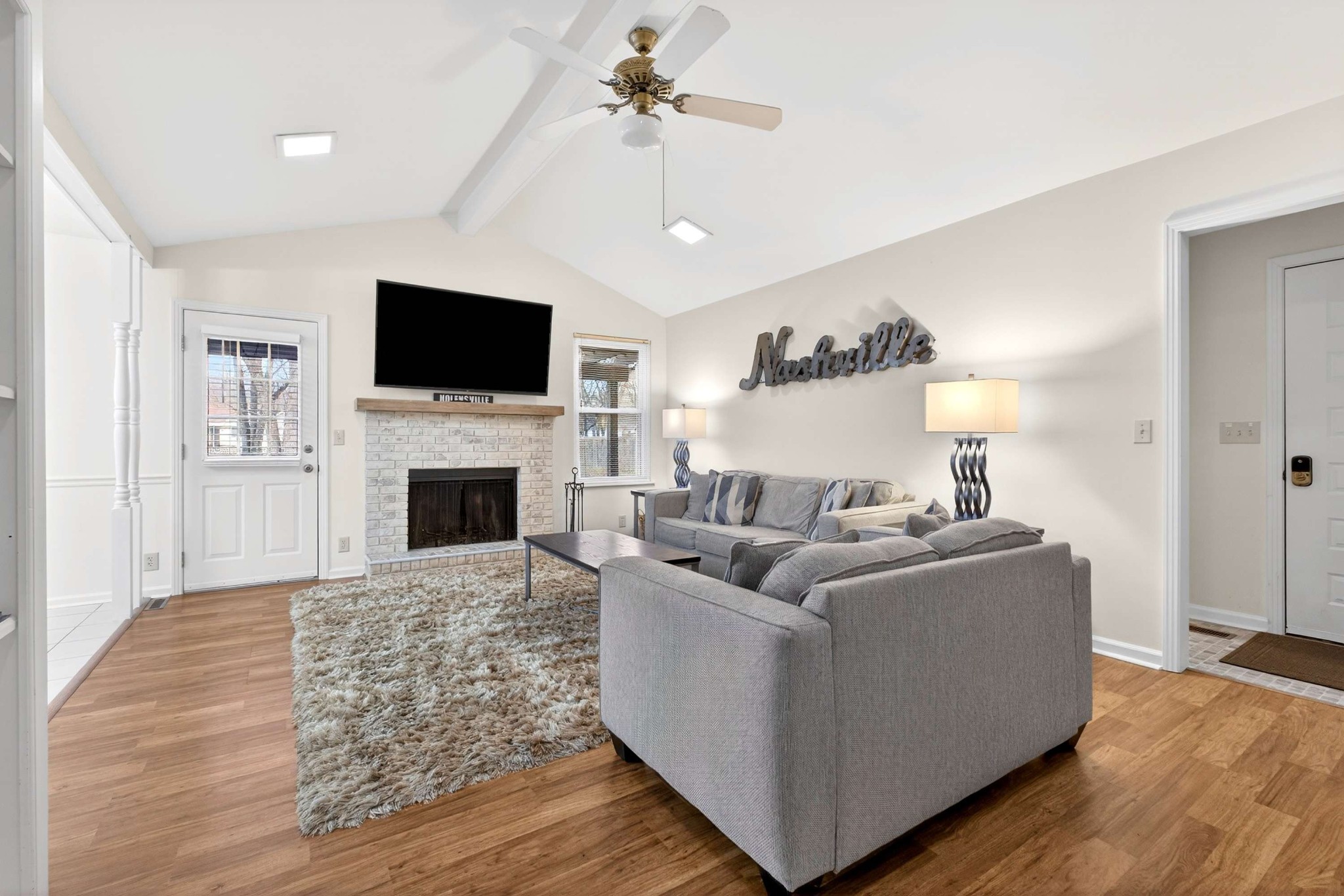 205 Stoneyway Court Nolensville, TN 37135 - Photo 12 of 41 a living room with furniture a flat screen tv and a fireplace