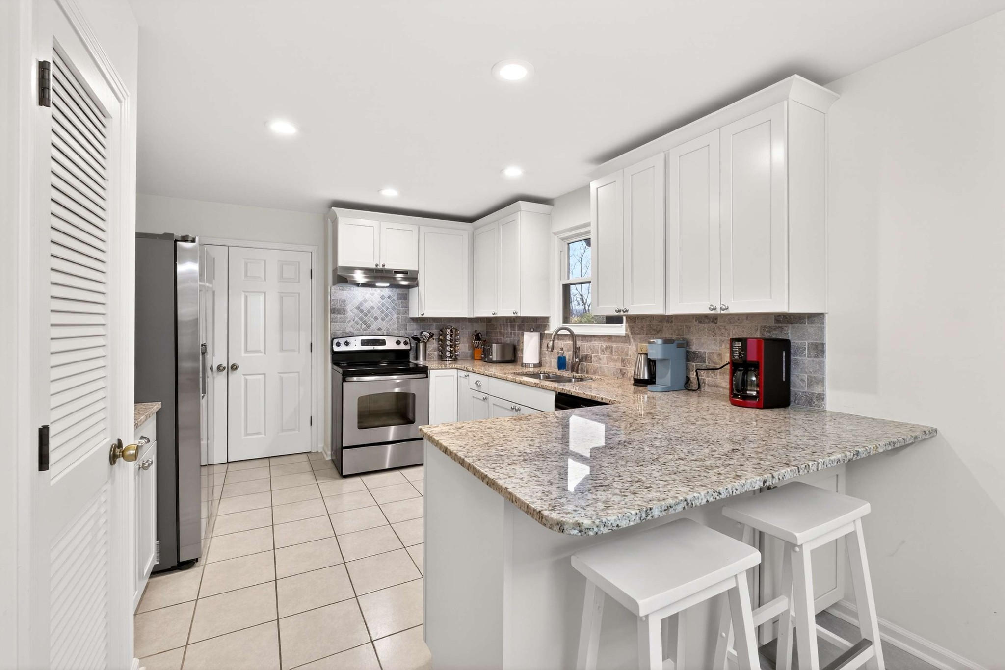 205 Stoneyway Court Nolensville, TN 37135 - Photo 18 of 41 a kitchen with stainless steel appliances granite countertop a stove a sink and a refrigerator