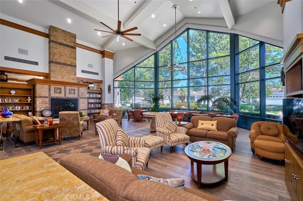 1143 Saguara Road Beaumont, CA 92223 - Photo 60 of 66 a living room with furniture a ceiling fan and a large window