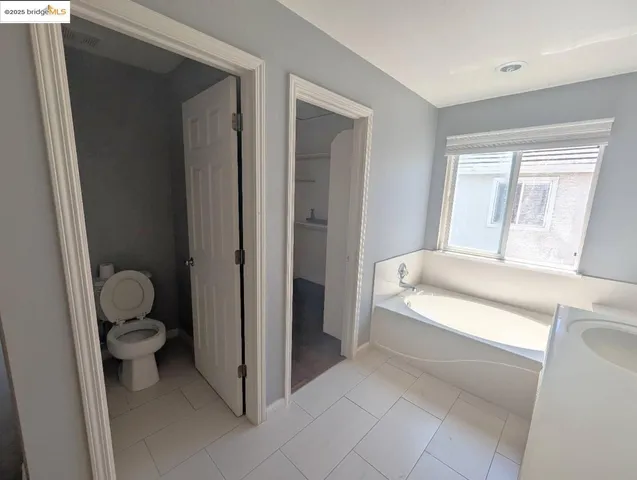 a bathroom with a toilet and a bathtub