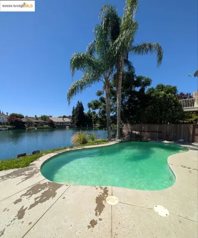 a view of a swimming pool with a yard