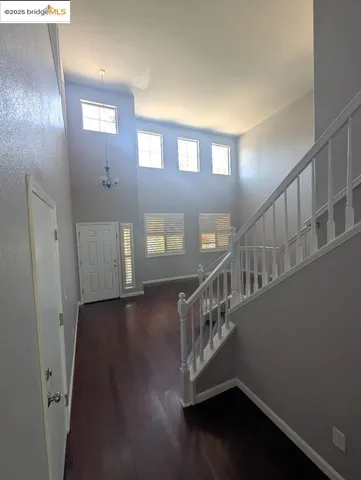 a view of entryway and hall with wooden floor