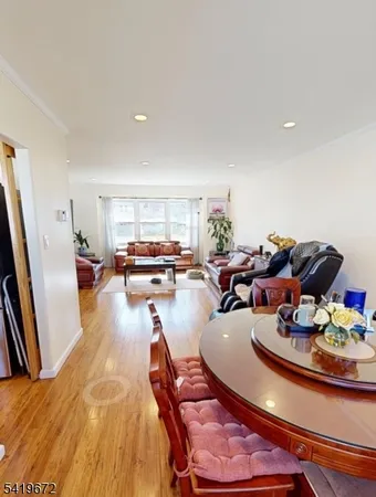 a dining room with furniture and a wooden floor