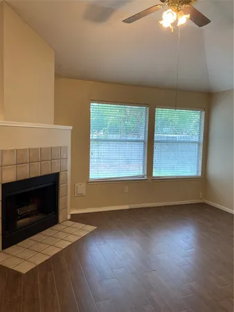 a view of a livingroom with a ceiling fan and window