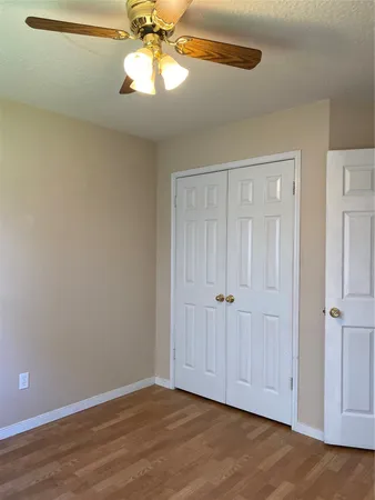 a view of wooden floor and windows in a room