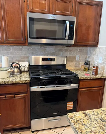 a kitchen with granite countertop cabinets sink and window