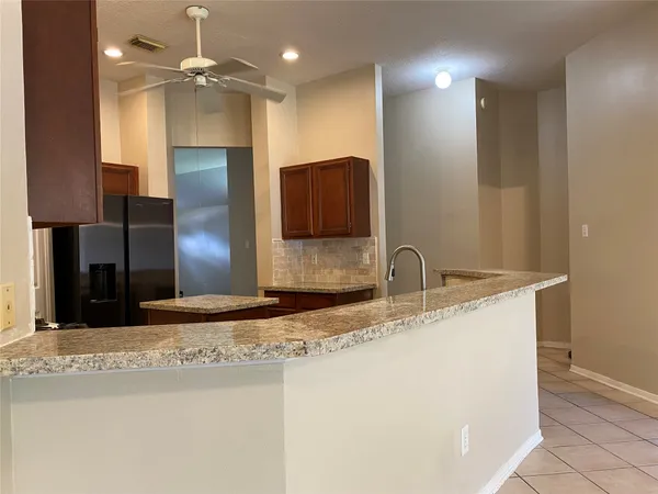 a kitchen with stainless steel appliances granite countertop a refrigerator and a sink