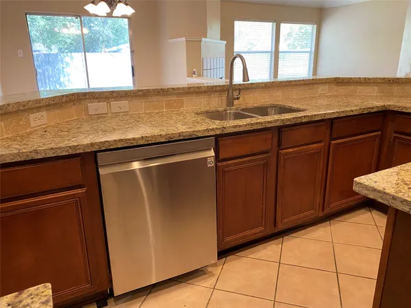 a bathroom with a granite countertop sink a mirror and shower