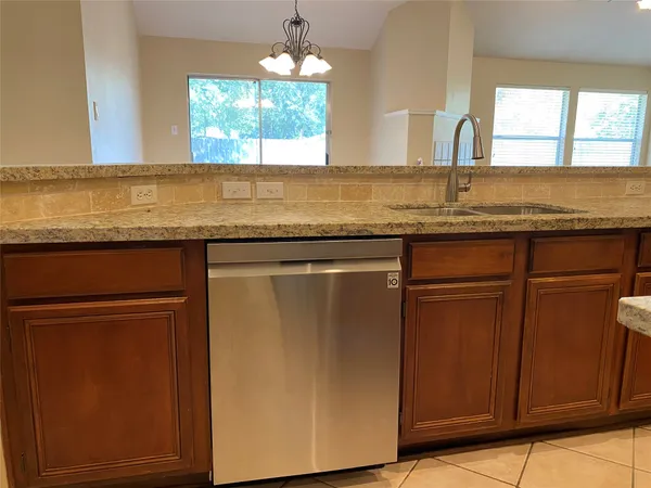 a view of a room with a chandelier and sink