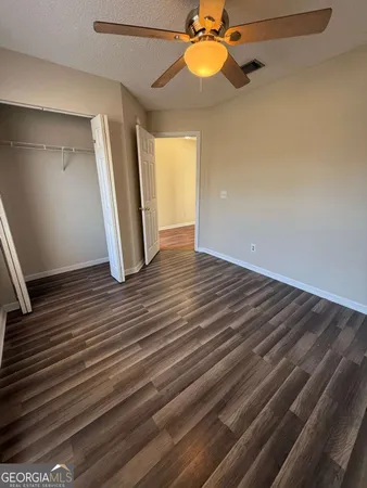 a view of a room with wooden floor and staircase