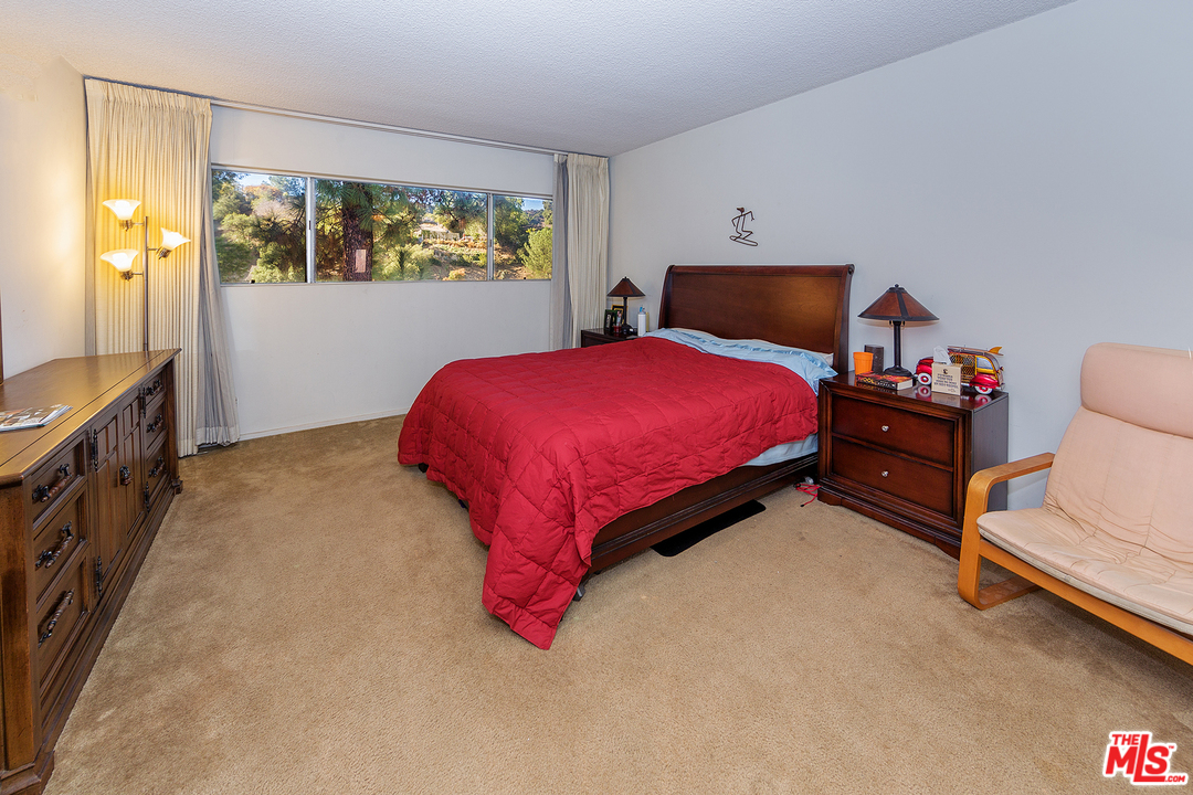 3088 Paddington Road Glendale, CA 91206 - Photo 13 of 17 a bedroom with a bed and wooden floor