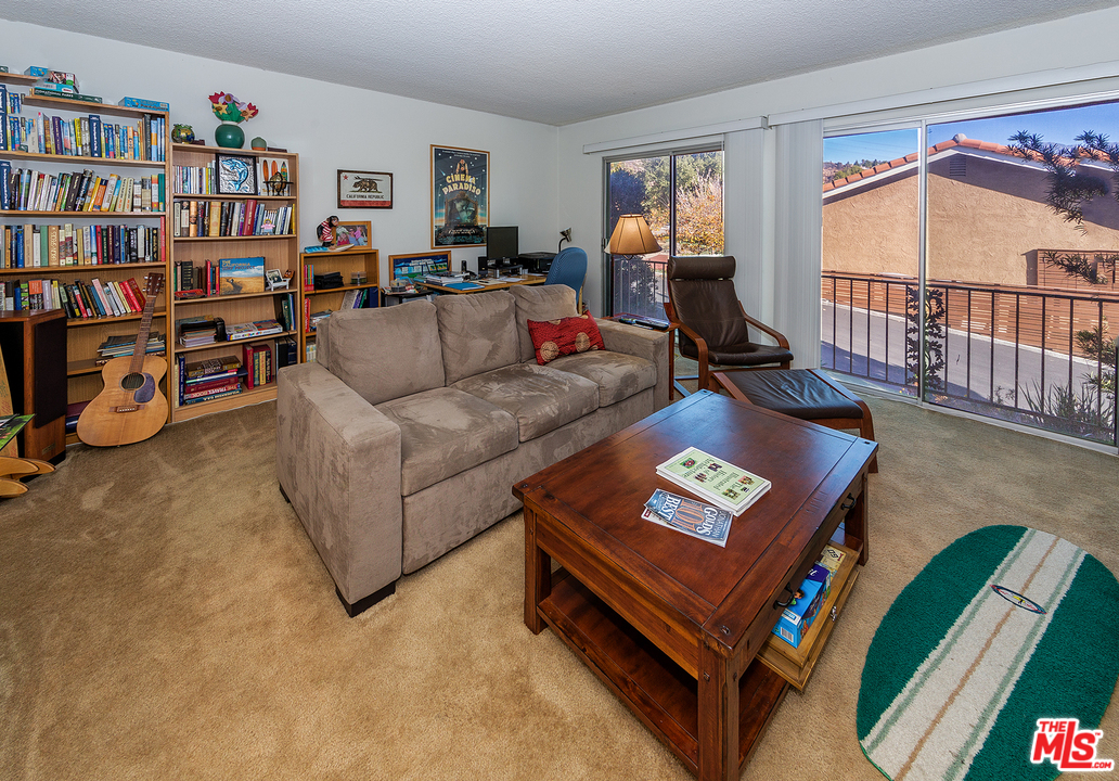 3088 Paddington Road Glendale, CA 91206 - Photo 5 of 17 a living room with furniture and a book shelf