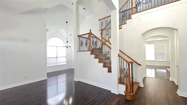 a view of entryway with wooden floor and stairs