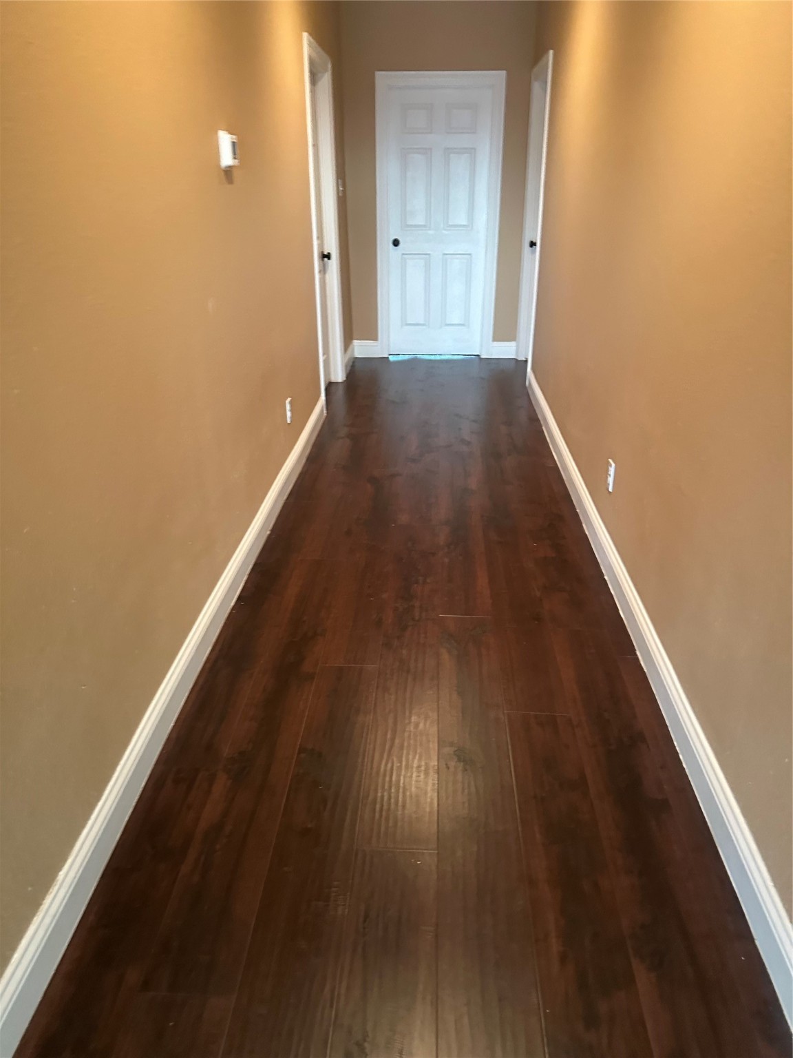 205 Rue Orleans Street Baytown, TX 77520 - Photo 11 of 43 a view of a hallway with wooden floor