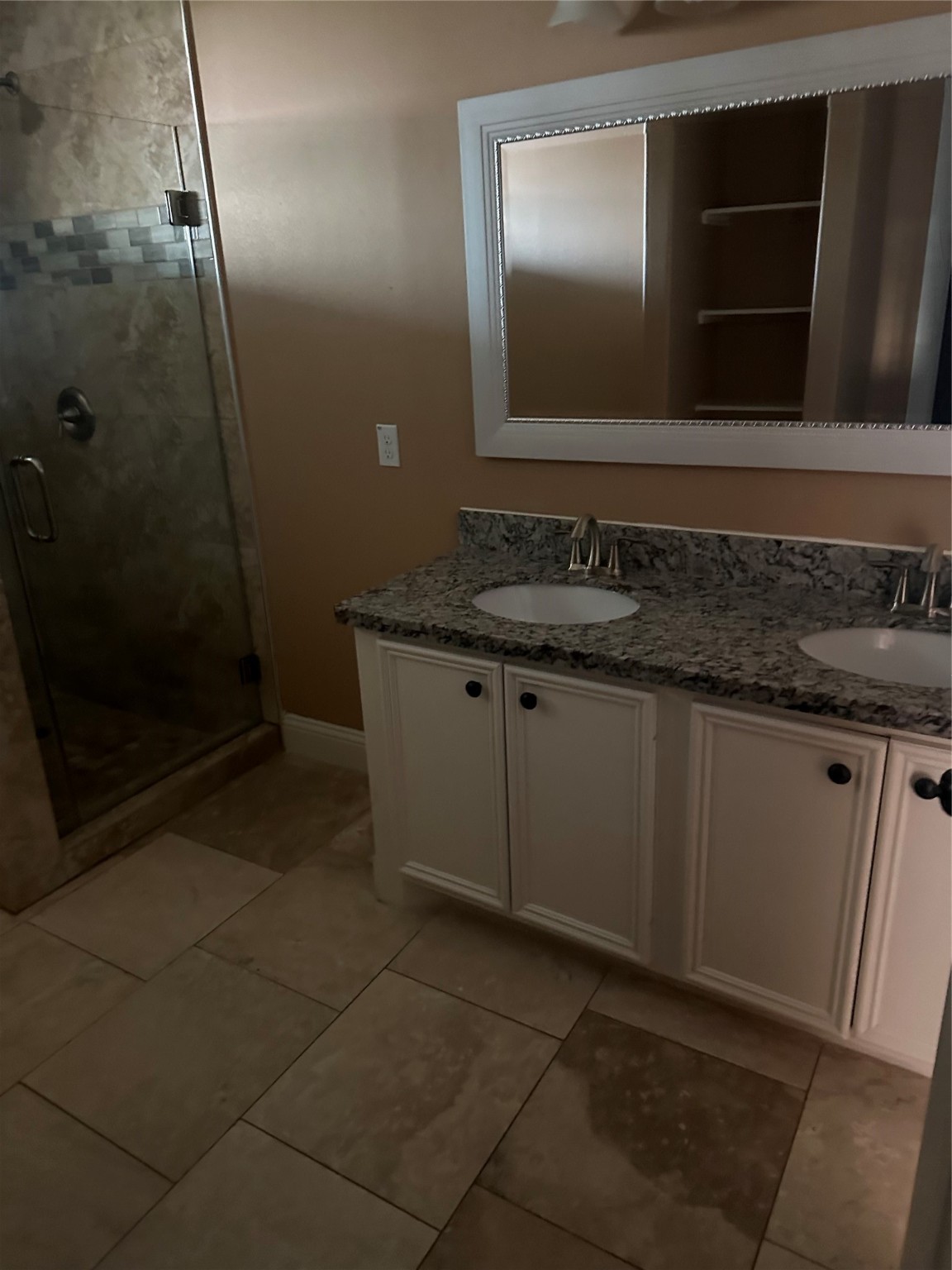 205 Rue Orleans Street Baytown, TX 77520 - Photo 22 of 43 a bathroom with a granite countertop sink a mirror and a shower