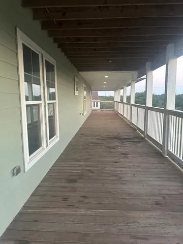 a view of a house with brick walls and a fence