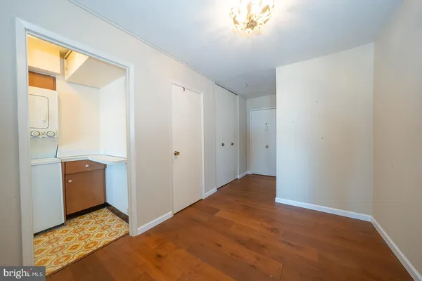 a view of hallway with a window and a kitchen