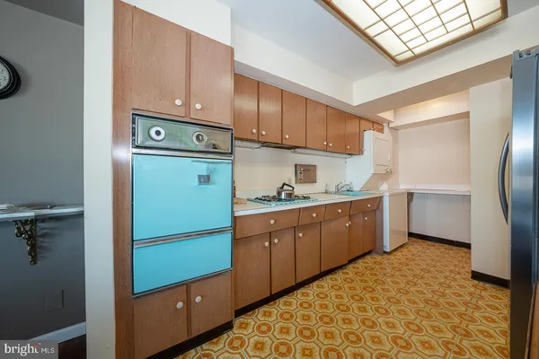 a kitchen with a refrigerator sink and cabinets