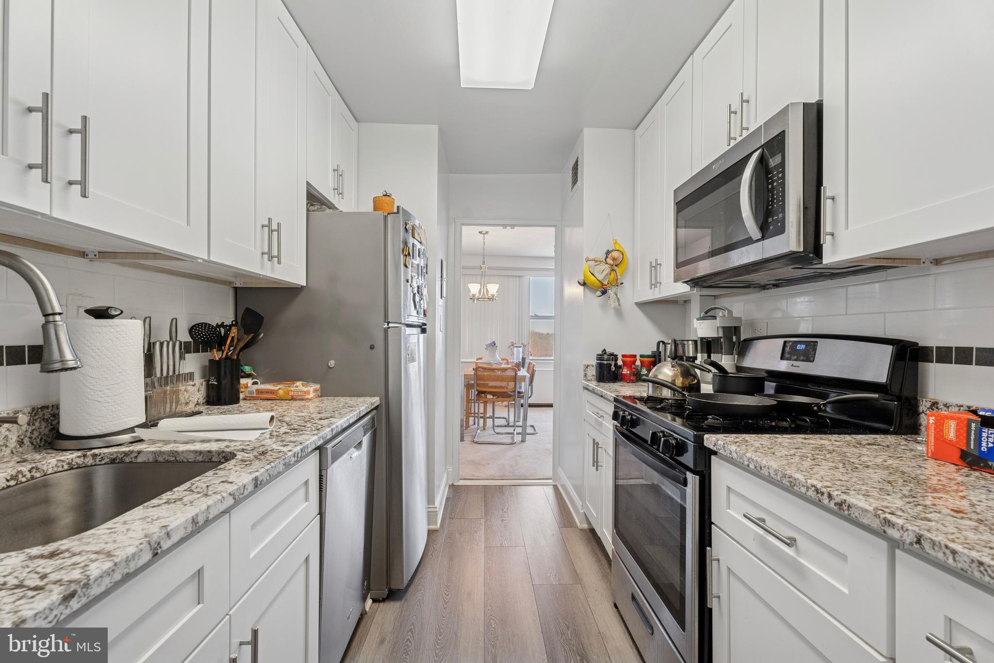 1600 Hagys Ford Road, Unit 8U Penn Valley, PA 19072 - Photo 14 of 44 a kitchen with stainless steel appliances granite countertop a stove a sink and a microwave