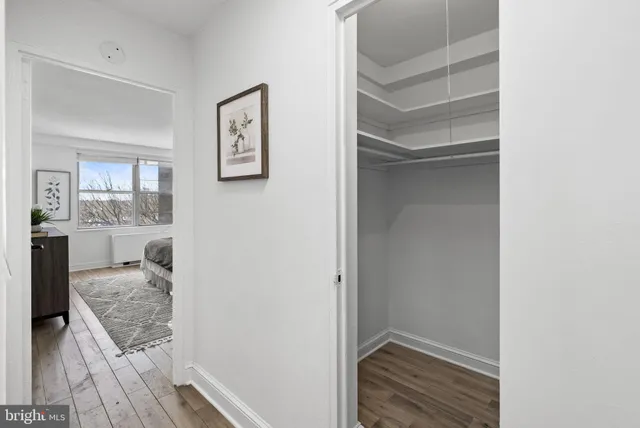 a hallway with cabinets and wooden floor