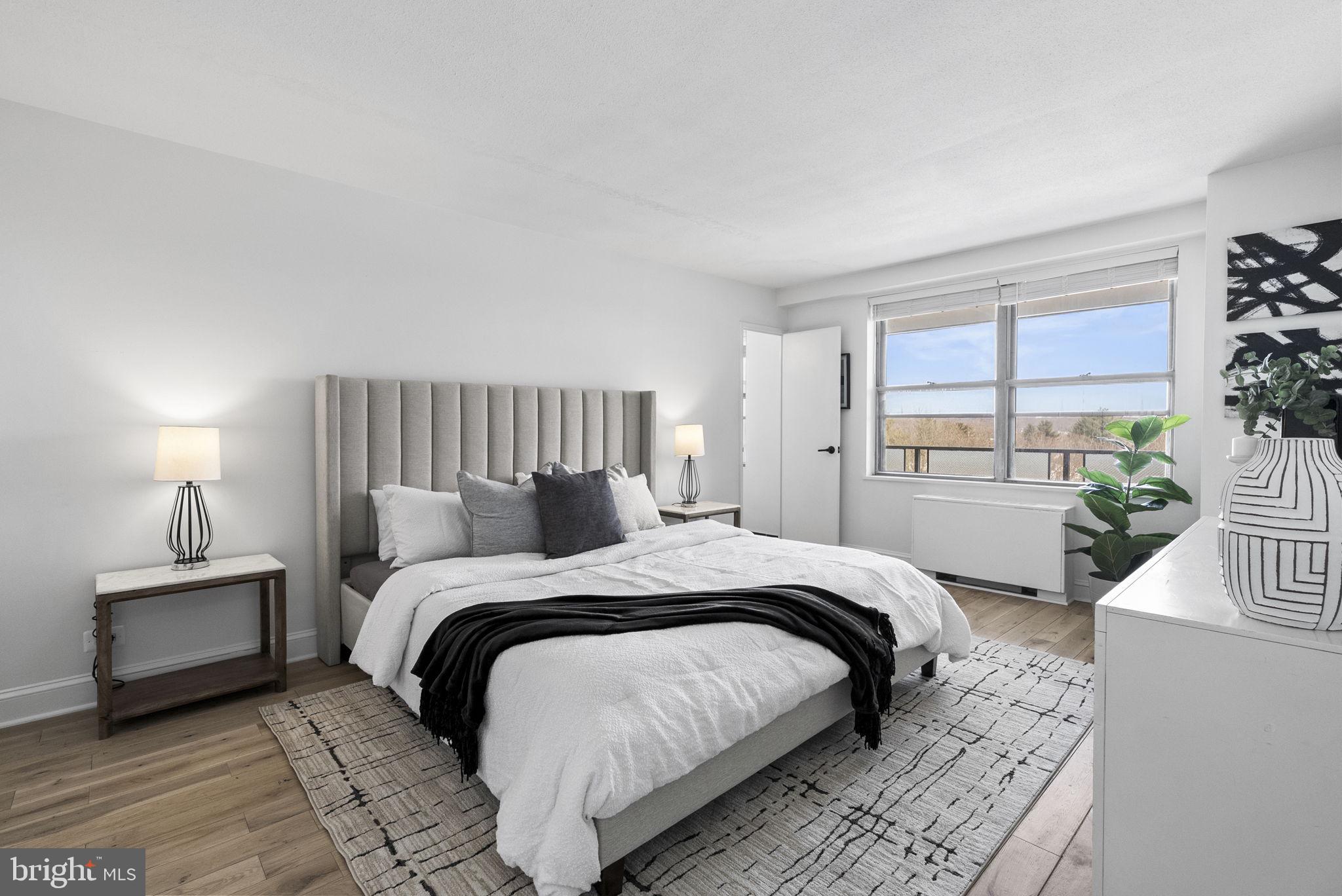 1600 Hagys Ford Road, Unit 8U Penn Valley, PA 19072 - Photo 19 of 44 a bedroom with a large bed and a window