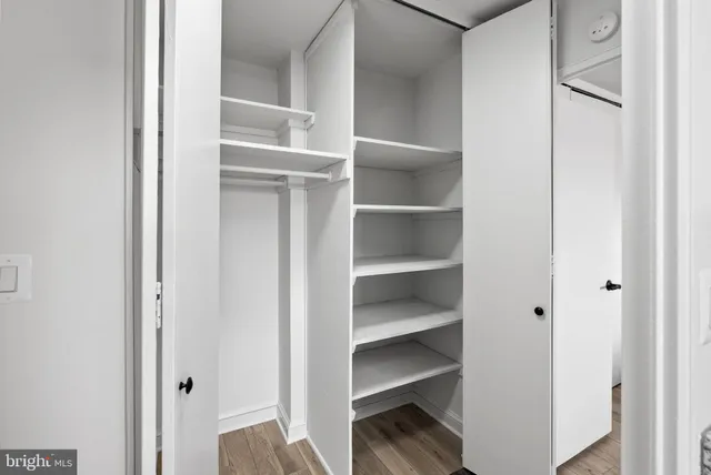 a view of a walk in closet with empty racks