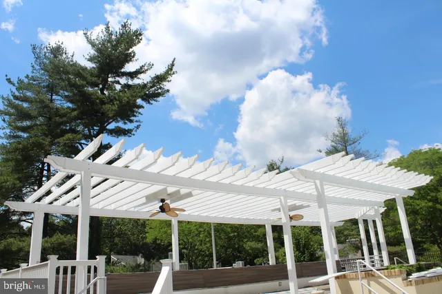 a view of a patio with table and chairs under an umbrella
