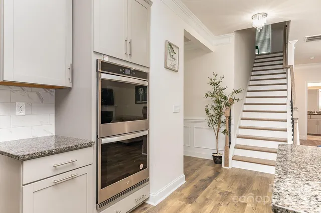 a kitchen with granite countertop a refrigerator and a sink