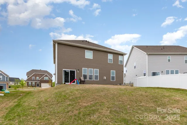 a front view of a house with large garden