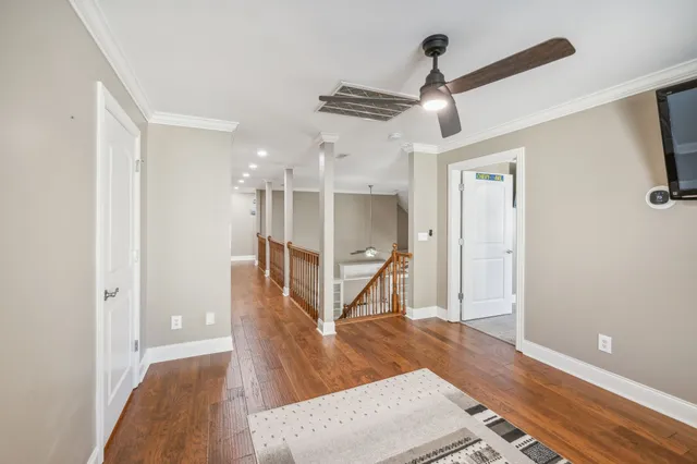 a view of entryway and hall with wooden floor