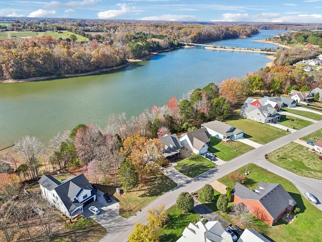 an aerial view of lake residential house with swimming pool and ocean view