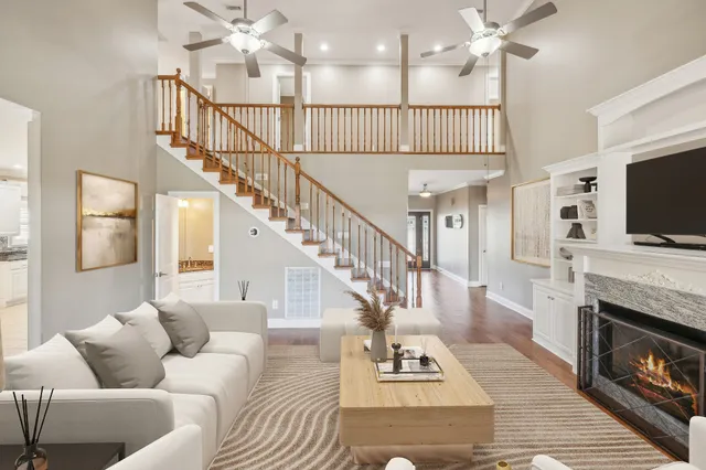a living room with fireplace furniture and a flat screen tv