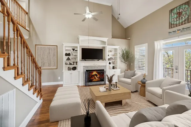 a living room with furniture a fireplace and a flat screen tv