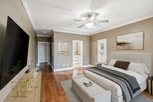 a bedroom with a large bed and a flat screen tv